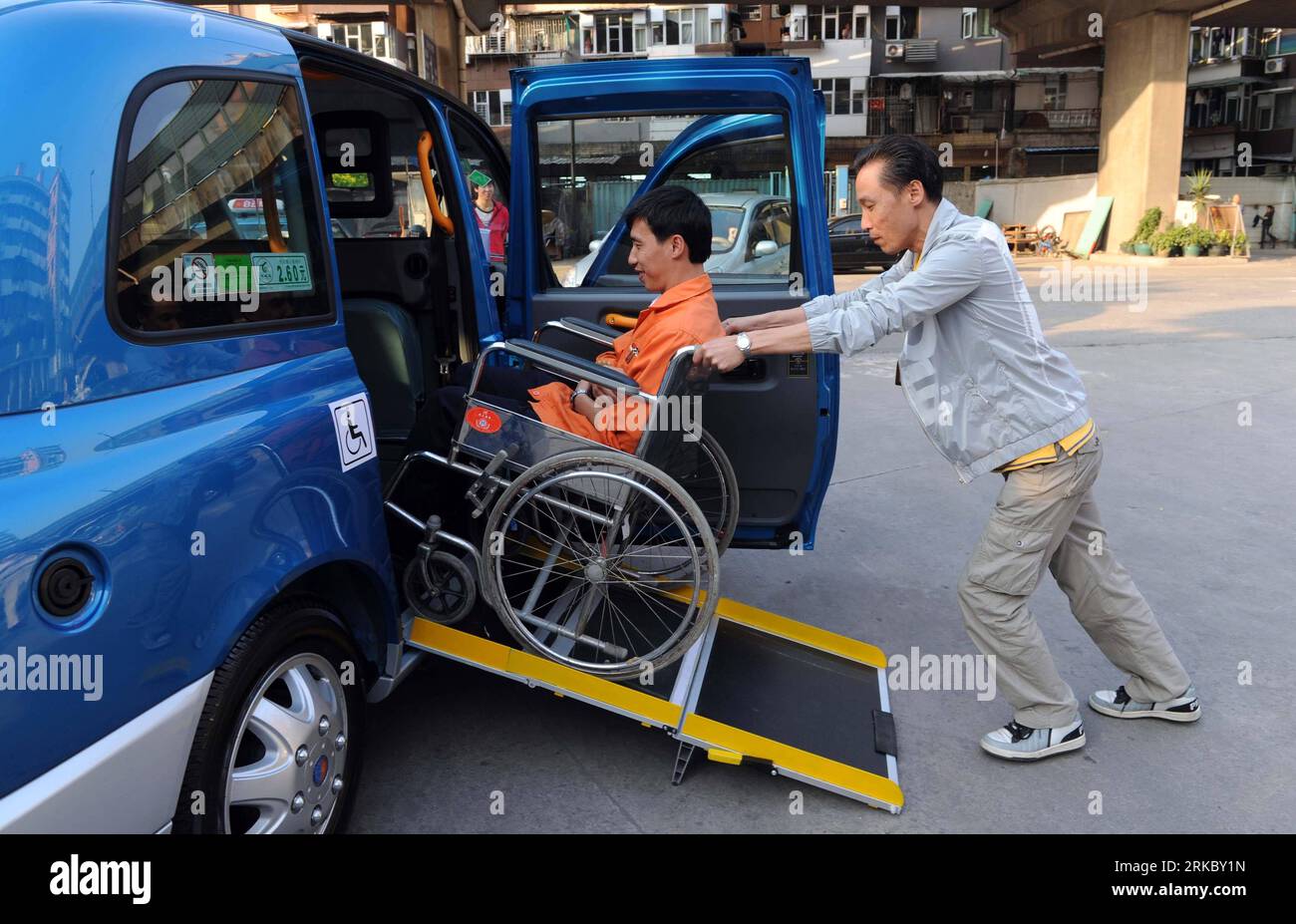 Bildnummer: 54625404  Datum: 09.11.2010  Copyright: imago/Xinhua (101109) -- GUANGZHOU, Nov. 9, 2010 (Xinhua) -- An employee in wheelchair is helped onto a barrier-free taxi by foldable steel board at Baiyun Taxi Service Company in Guangzhou, south China s Guangdong Province, Nov. 9, 2010. A total of 100 barrier-free taxis are put on road to serve disabled during the the 16th Asian Games. (Xinhua/Yang Shiyao) CHINA-GUANGZHOU-ASIAN GAMES-BARRIER-FREE TAXI PUBLICATIONxNOTxINxCHN Gesellschaft Behindertengerecht Taxi barrierefrei Rollstuhltaxi Behindertentaxi kbdig xsp 2010 quer     Bildnummer 546 Stock Photo