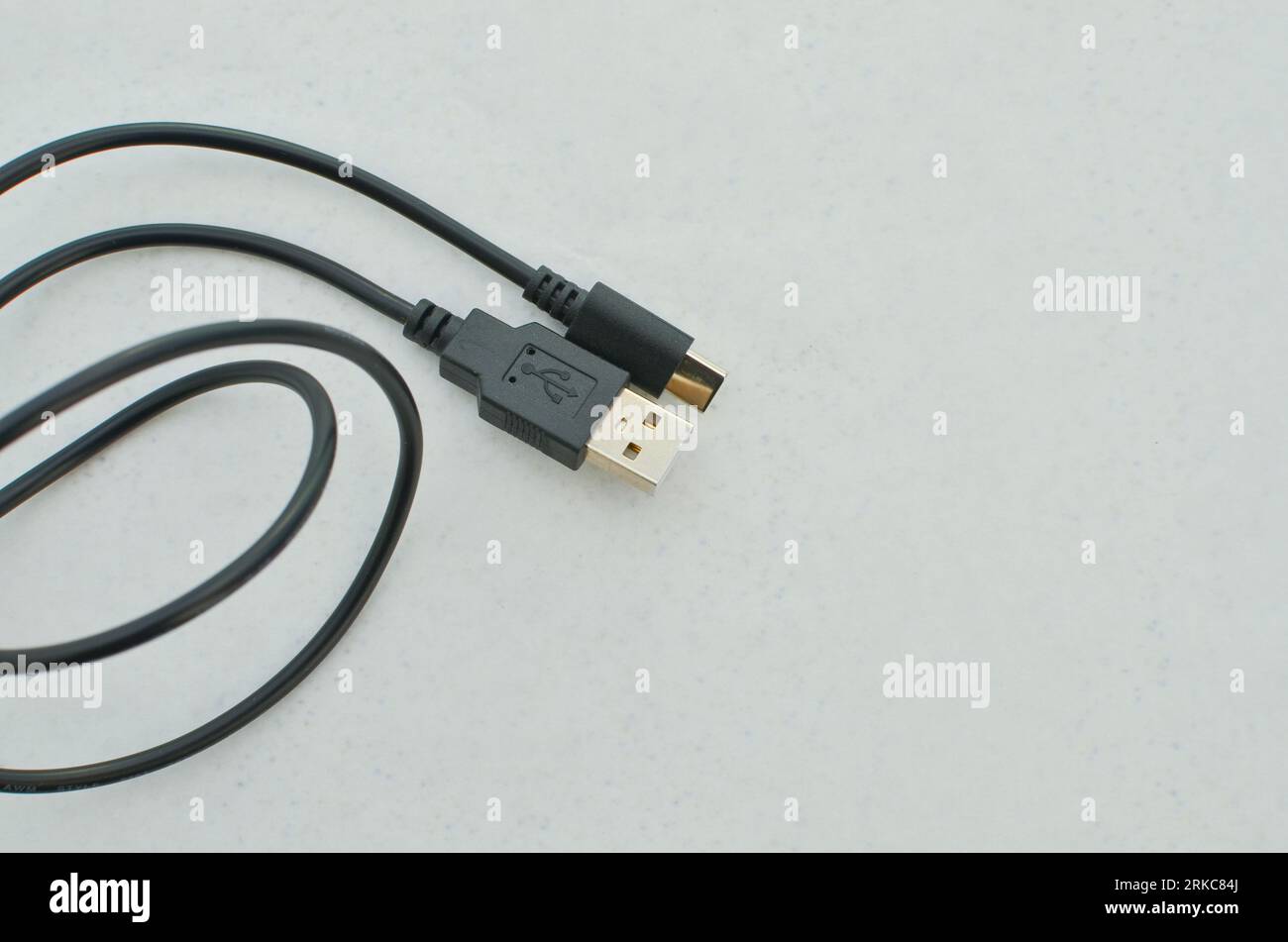 Black USB TypeC cable detail highlighted on a clear surface, perfect