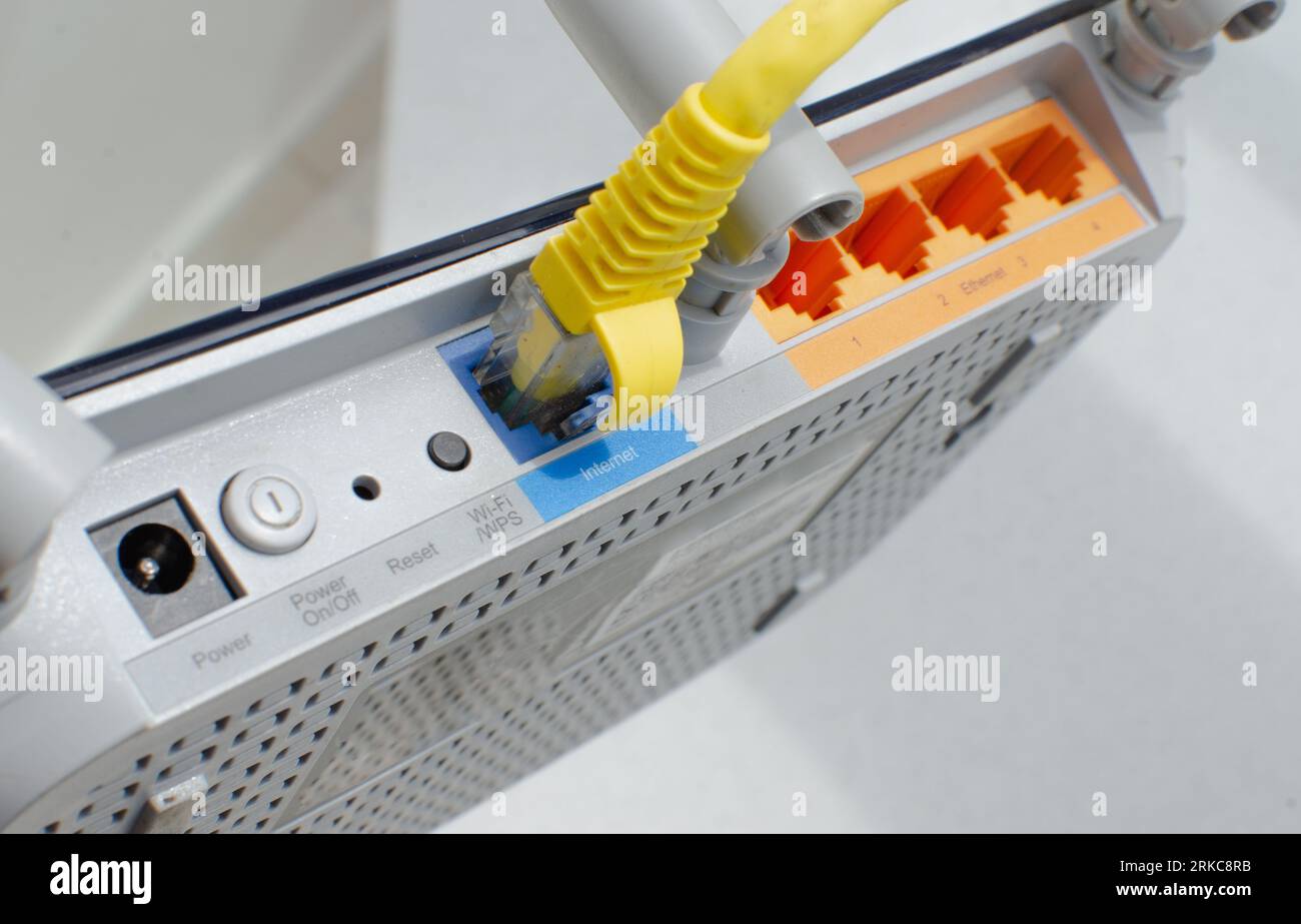 Closeup detail of a modern WiFi router, with multiple inputs and