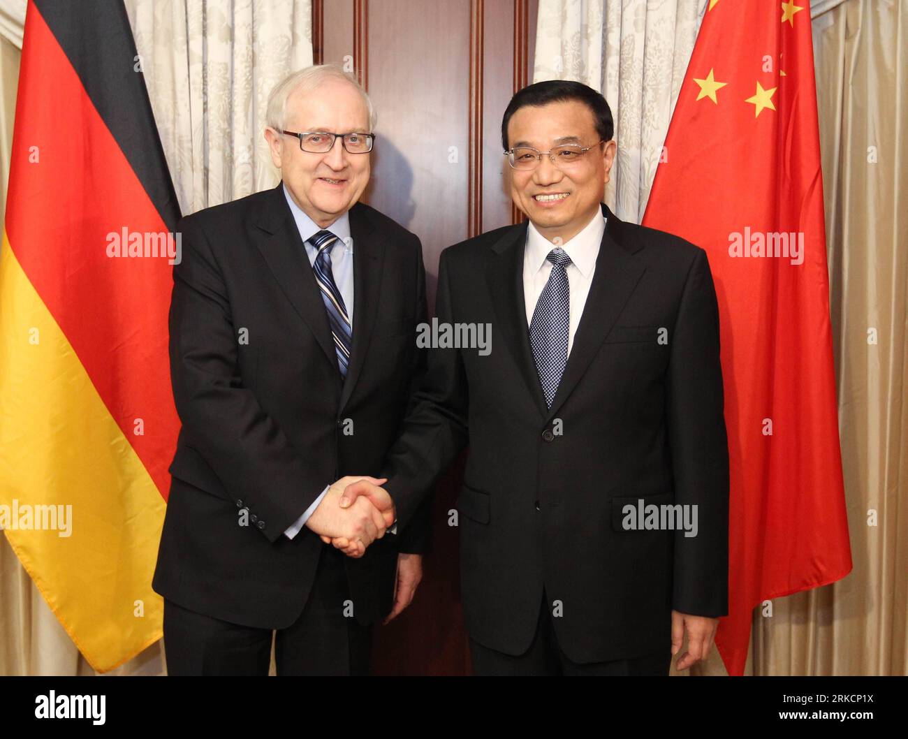110106 -- BERLIN, Jan. 6, 2011 Xinhua -- Chinese Vice Premier Li Keqiang R shakes hands with German Economy Minister Rainer Brüderle in Berlin, Germany, Jan. 6, 2011. Xinhua/Ding Linwyo GERMANY-CHINA-LI KEQIANG-MEETING PUBLICATIONxNOTxINxCHN Stock Photo