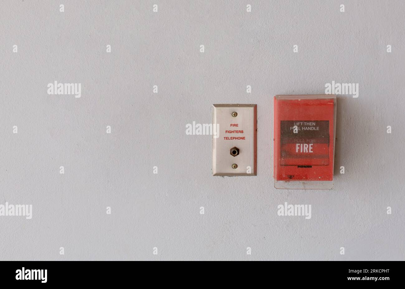 Red fire alarm switch on concrete wall in office building Industrial Emergency Fire Alarm System