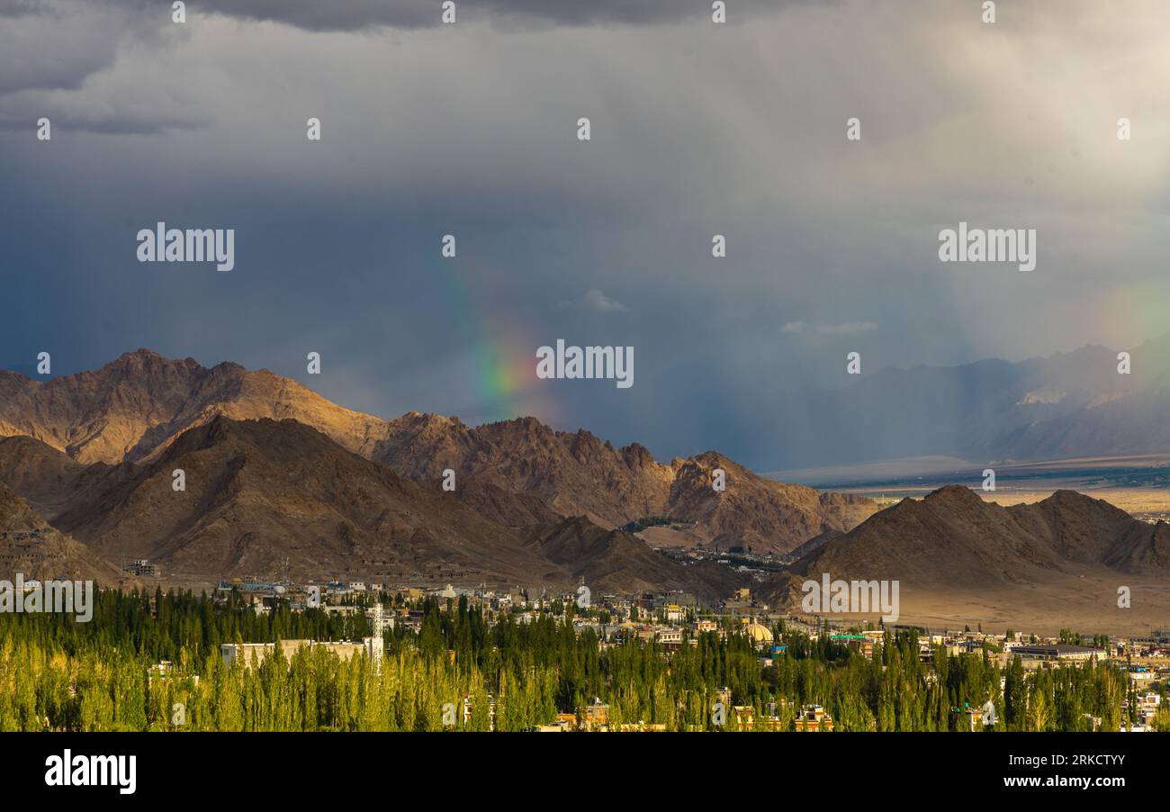 Mountains, clouds and blue sky with Leh town in foreground captured on 10 August 2023 Stock Photo
