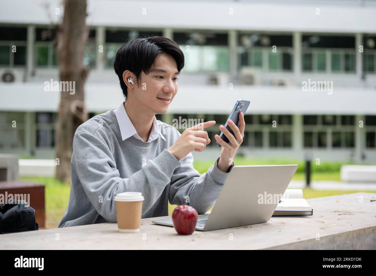 A happy and handsome young Asian male college university student ...