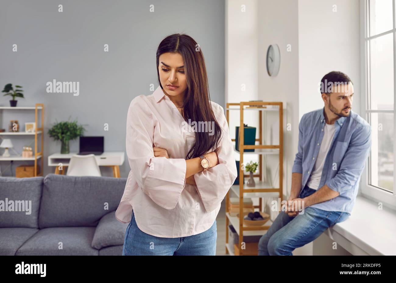 Stressed family couple arguing at home, facing away from each other Stock Photo
