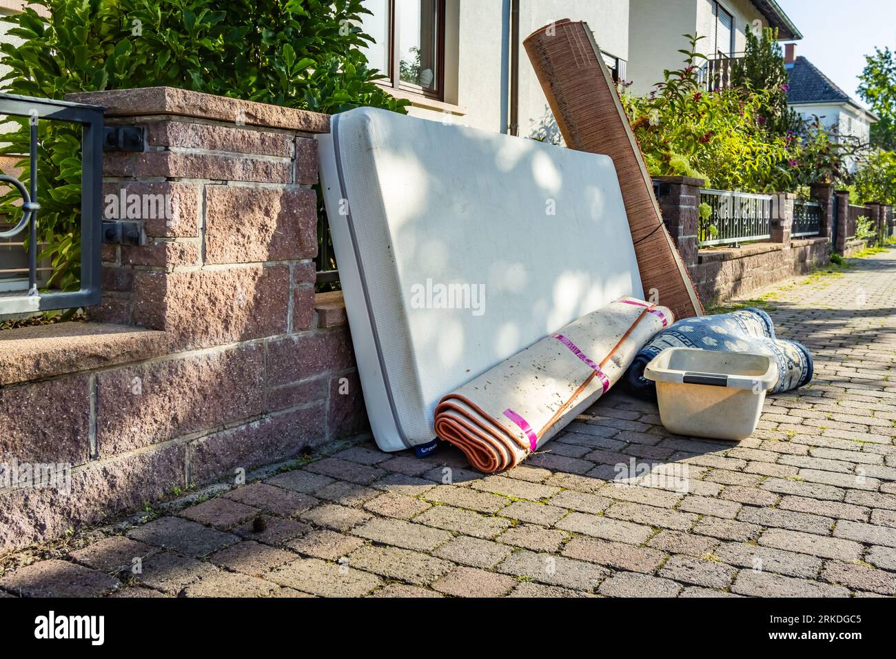Bulk garbage day concept, miscellaneous rubbish items put on a street for council bulk waste collection, bulky waste and waste management Stock Photo