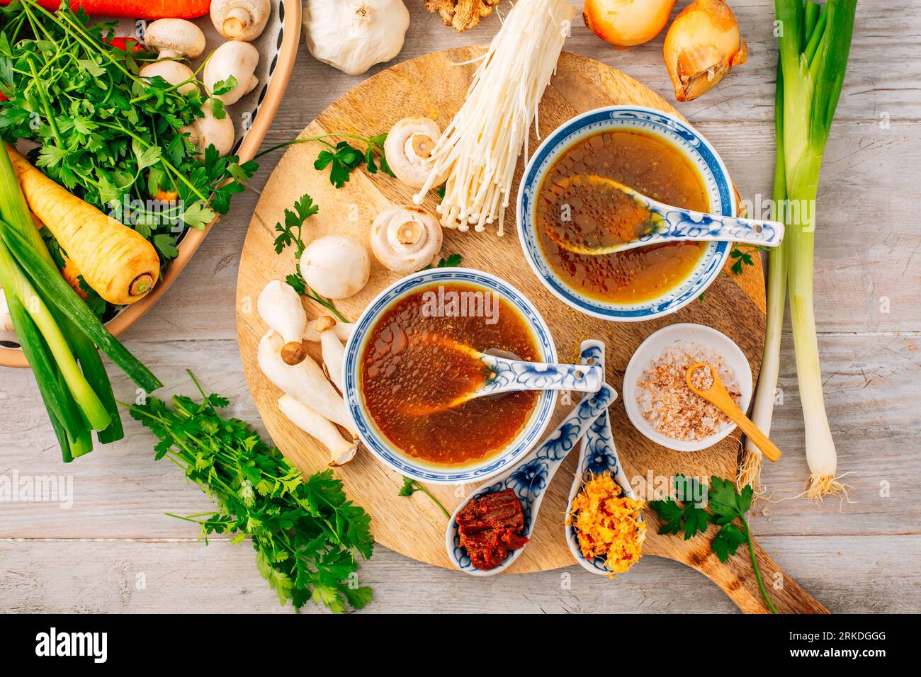 Miso, ramen or vegetable broth with ingredients on wooden background Stock Photo