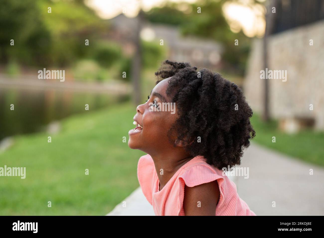 African Amerian little girl smiling outside Stock Photo - Alamy