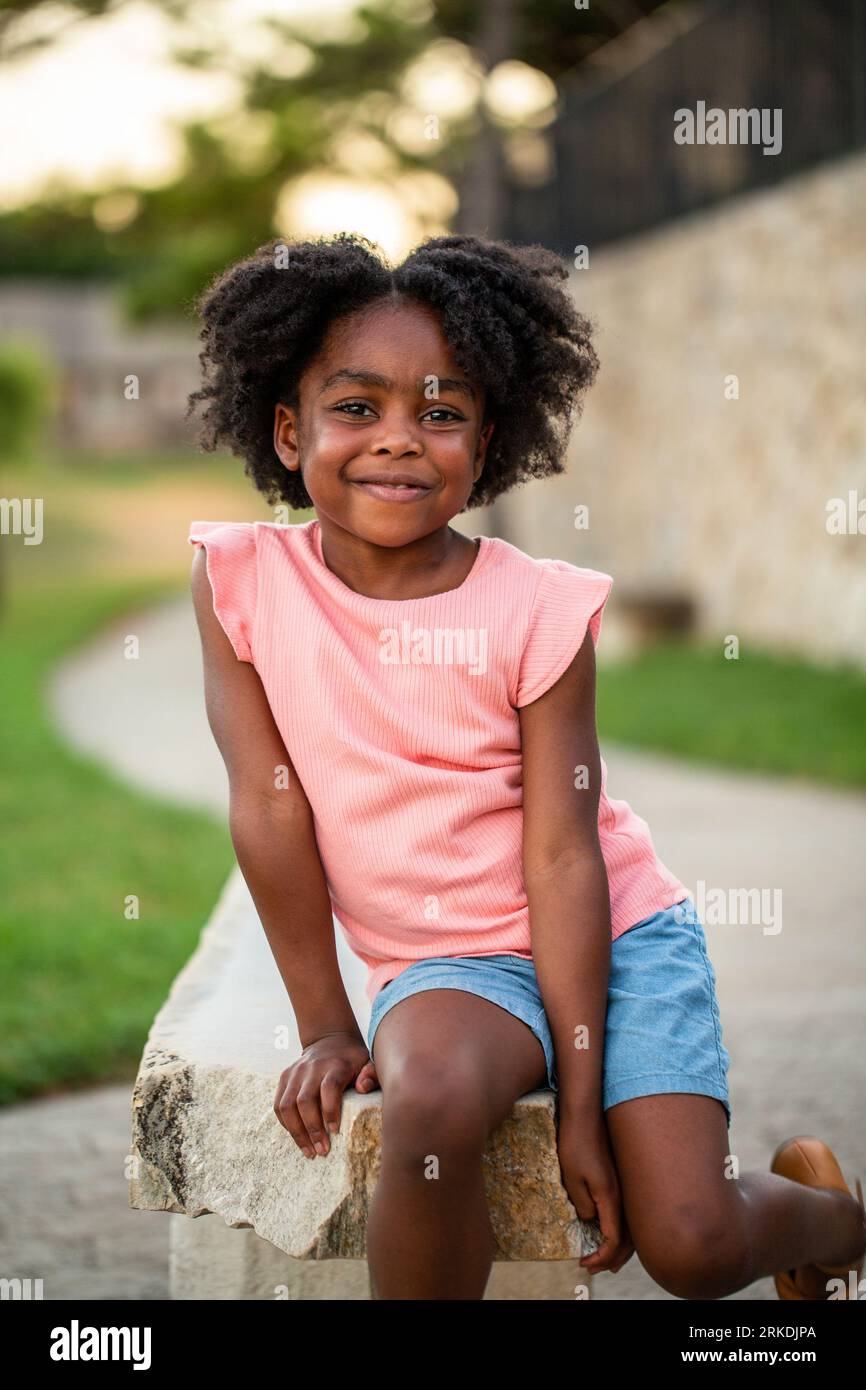 African Amerian little girl smiling outside Stock Photo - Alamy