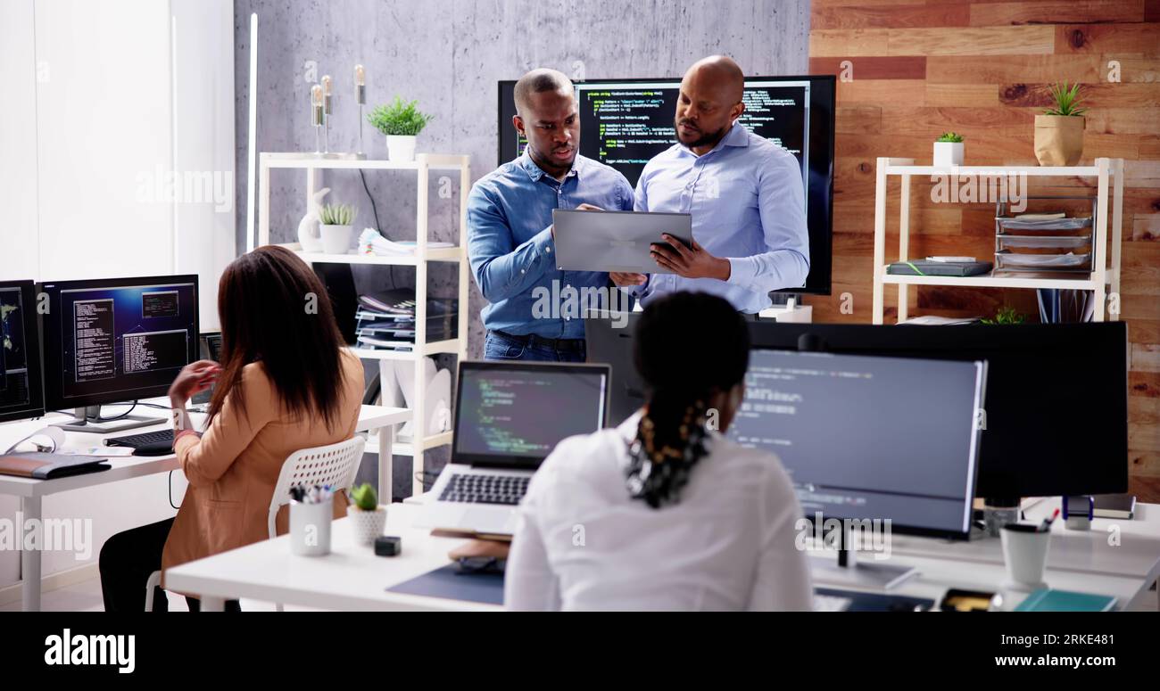 African Business Team Working On Computer. Software App Development Stock Photo