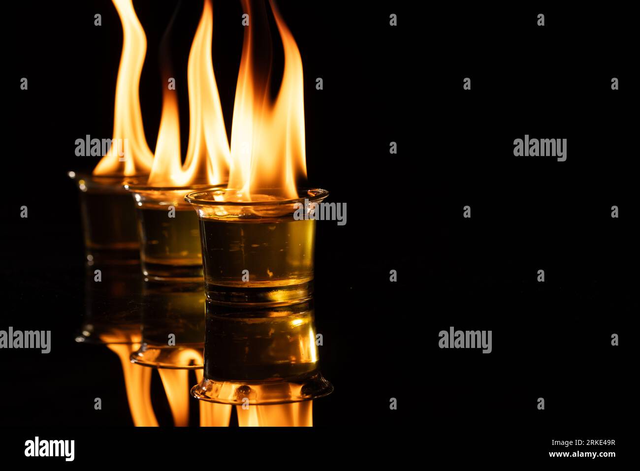 Three lit candles with copy space on black background Stock Photo