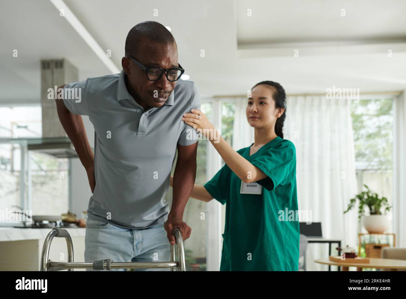 Patient crying from acute pain in lower back when trying to make steps