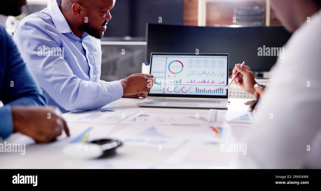 Financial Advisor Group Meeting Examining Analytics Dashboard Stock