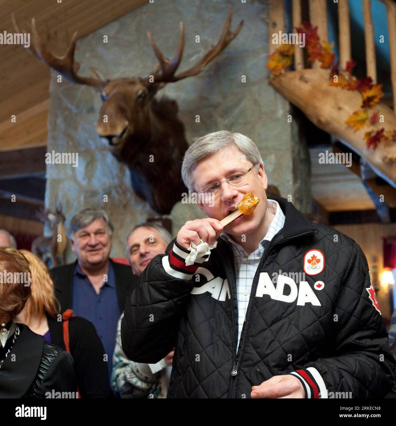 (110405) -- OTTAWA, April 5, 2011 (Xinhua) -- Canada s Prime Minister and Conservative Party leader Stephen Harper (R) tastes sweets at a sugar shack in Saint-Norbert-D arthabaska, Quebec, Canada, on April 5, 2011. Harper, who is on a campaign trip for a federal election on May 2, said that a re-elected Conservative government will support rural doctors and nurses and a tax credit for volunteer firefighters. (Xinhua/Canadian Conservative Party) (zw) CANADA-OTTAWA-ELECTION-HARPER PUBLICATIONxNOTxINxCHN Stock Photo