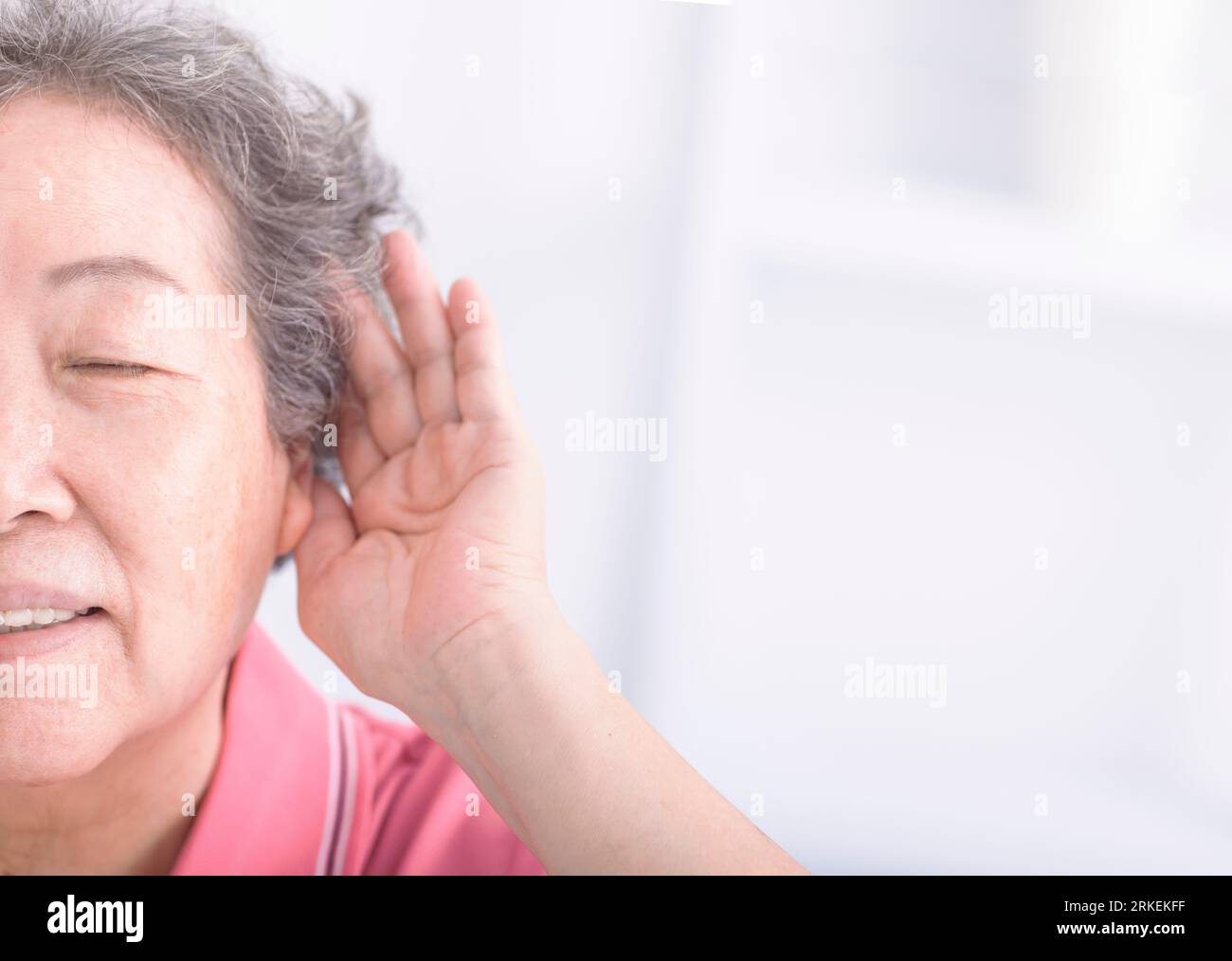 Closeup senior woman hearing loss , Hard of hearing Stock Photo