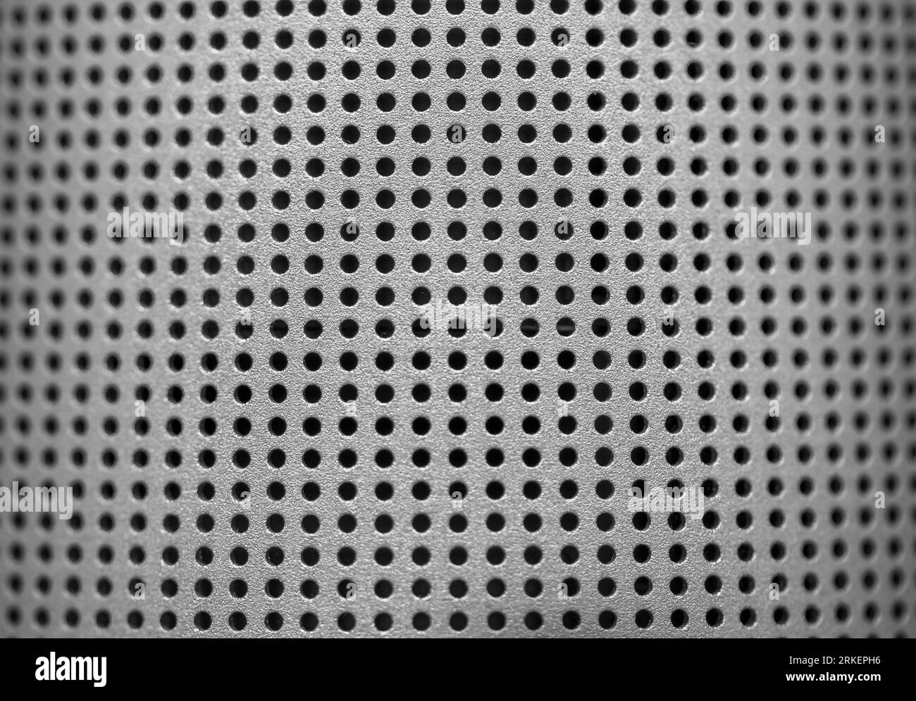 Silver speaker lattice closeup. Perforated metal texture. Modern