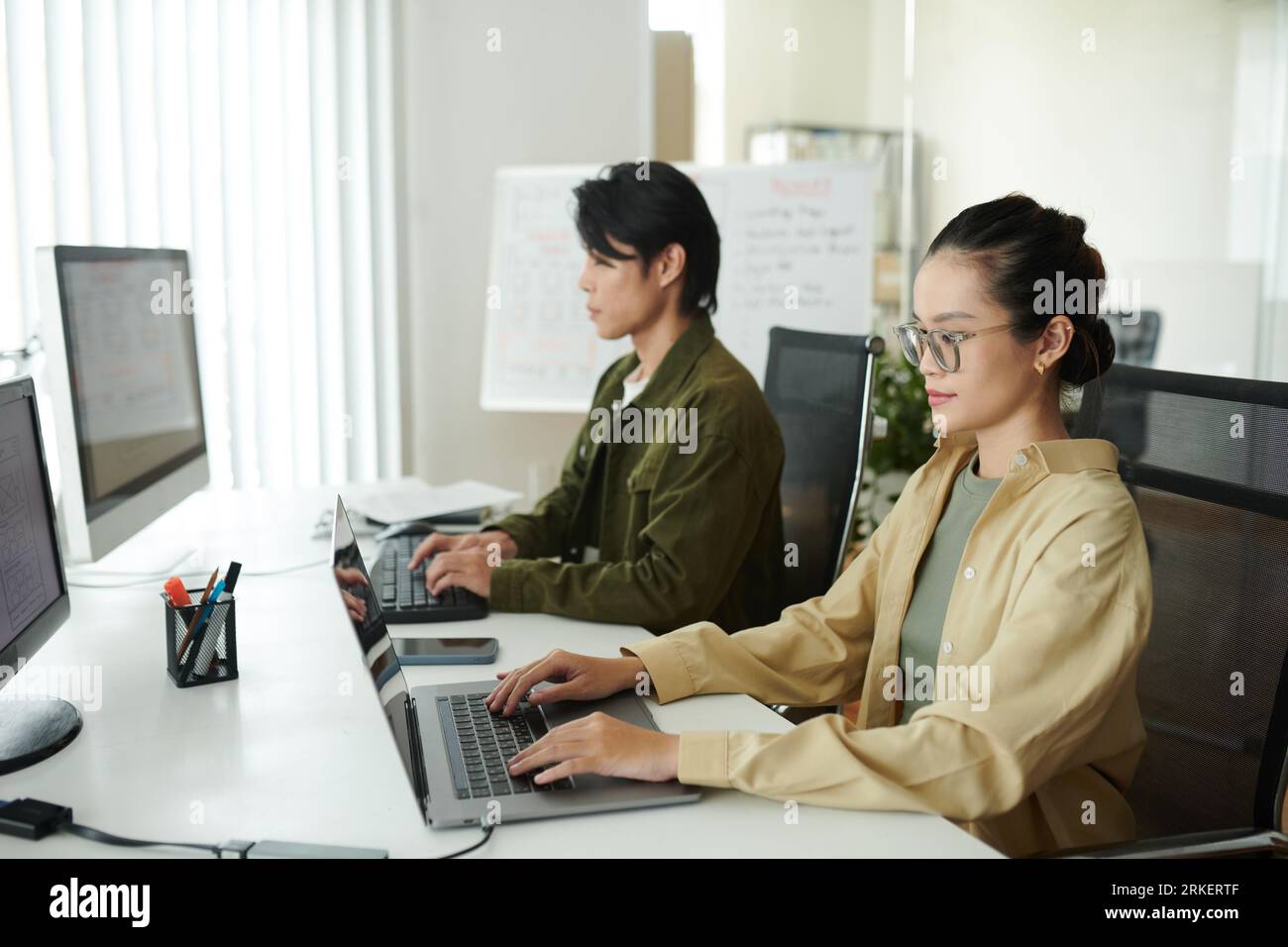 Software developers working on computers on new big project Stock Photo