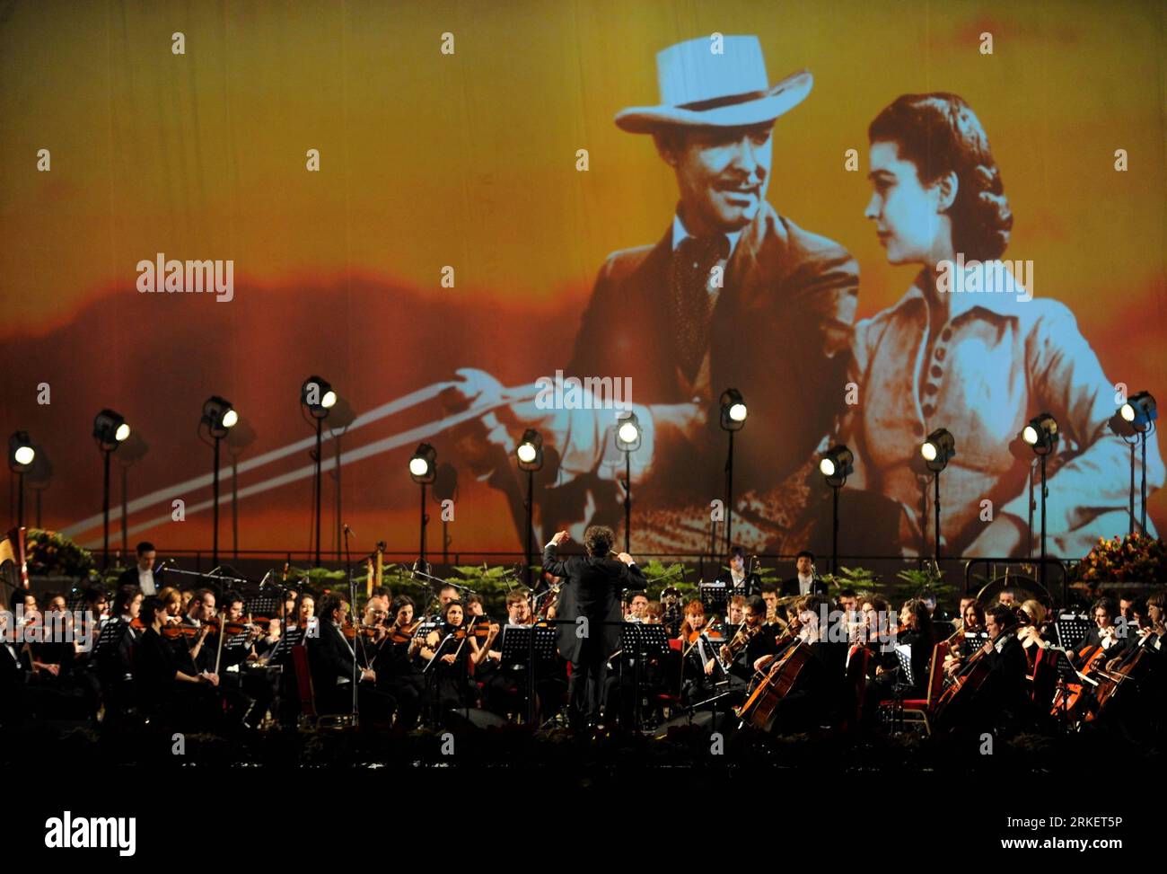 110426 -- BEIJING, April 26, 2011 Xinhua -- Musicians of the Italian cinema orchestra present the theme score of the Hollywood movie Gone With the Wind during a symphony concert at the People s Great Hall in Beijing, capital of China, April 26, 2011. The Italian cinema orchestra, together with Chinese singers, presented film scores of classic Chinese and foreign movies during a symphony concert, which was held here Tuesday as one of the events of the ongoing 1st Beijing International Film Festival. Xinhua/Luo Xiaoguang ljh CHINA-BEIJING-FILM SCORES-CONCERT CN PUBLICATIONxNOTxINxCHN Stock Photo