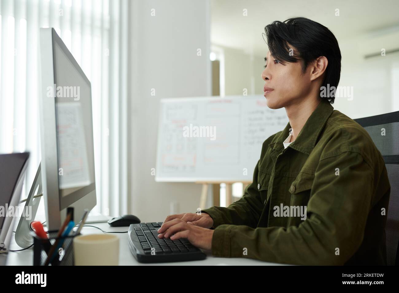 Portrait of serious software developer concentrated on reviewing programming code Stock Photo