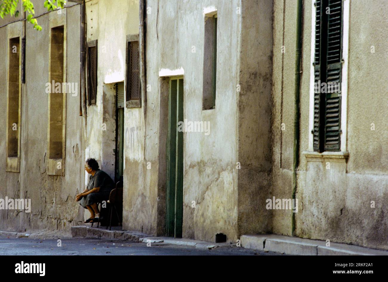 Nicosia Cyprus Old Town Elderly Woman Sitting on Front Porch of her House Stock Photo