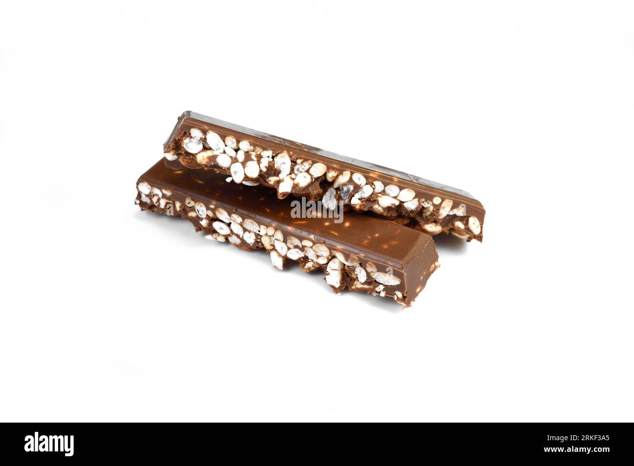 Chunks of milk chocolate with puffed rice isolated on white background