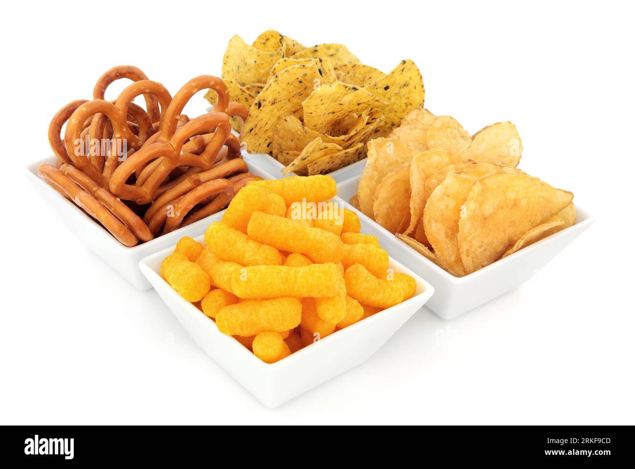 Snacks in a white porcelain dish. Mix of snacks on a white plate isolated on white. Stock Photo