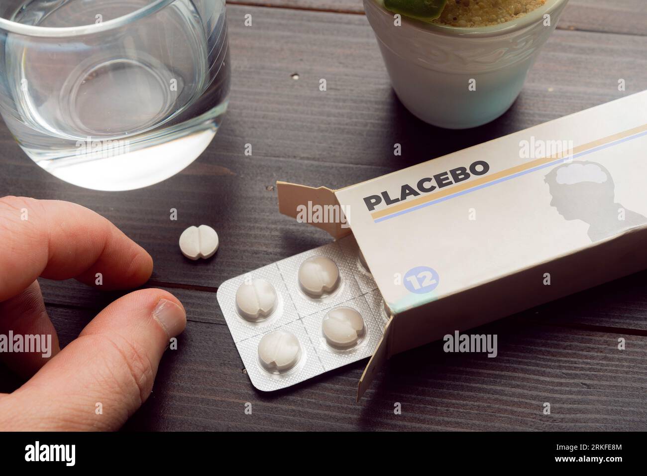 Placebo effect concept: man take a pill from a placebo box of pills Stock Photo