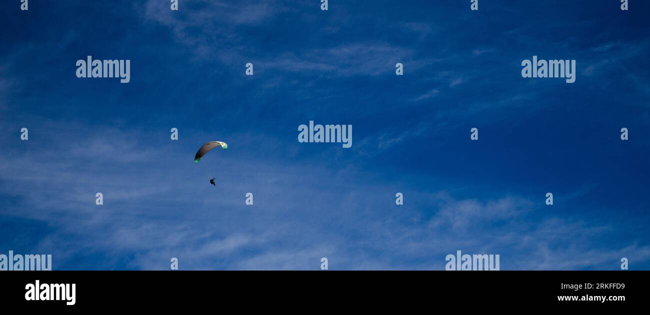 Parachute flying adventure in panoramic ratio Stock Photo