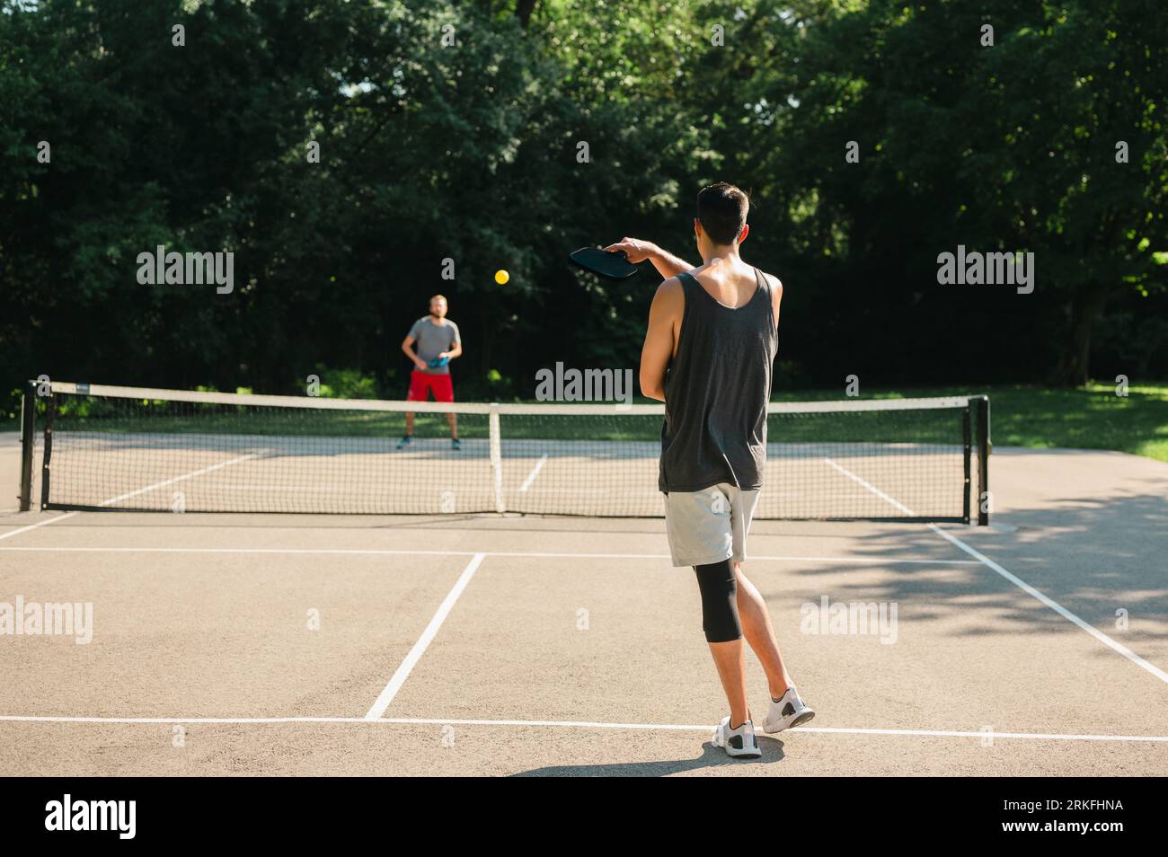 Two young people playing pickleball in the summer Stock Photo Alamy