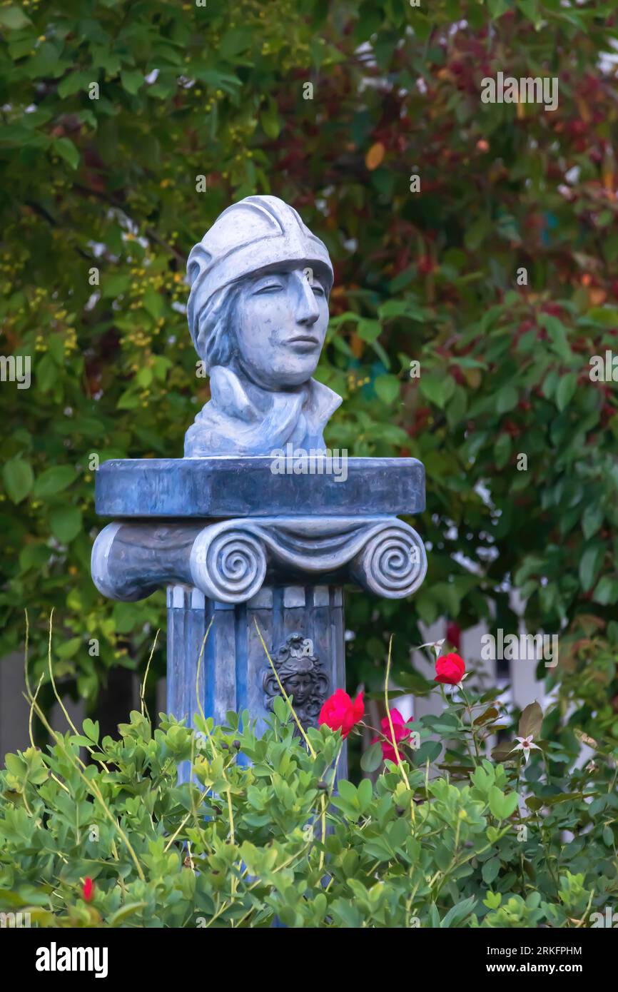Red roses and an elegant sculpture entitled "The Bicyclist" on a greek