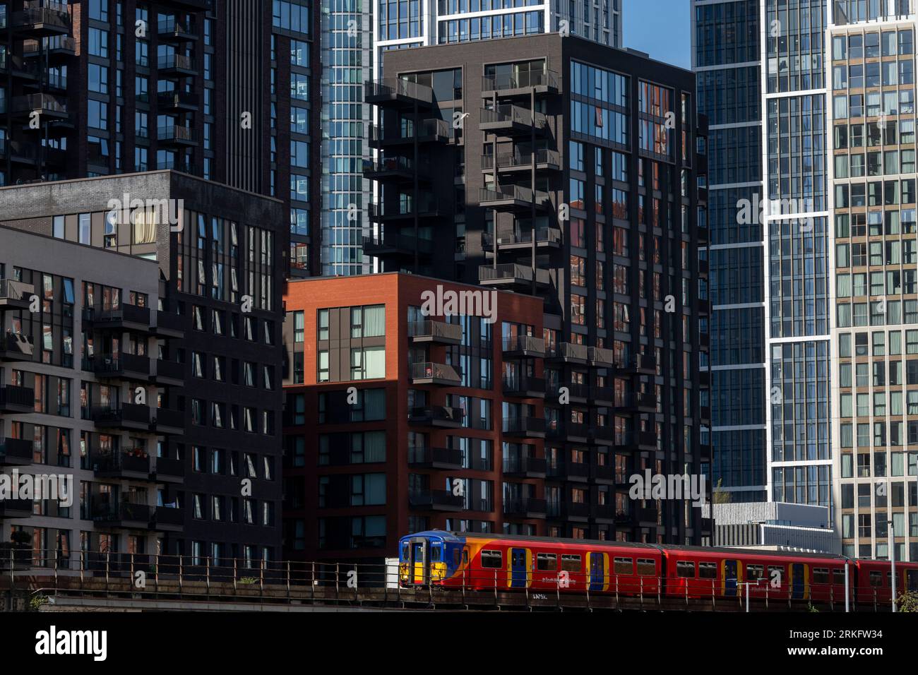 A train from Southwest Railways passing by newly constructed tower blocks in Nine Elms, South London. The tower blocks are part of a larger redevelopm Stock Photo