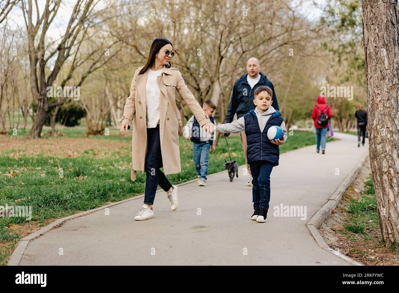 Happy family on a walk in the park Stock Photo - Alamy
