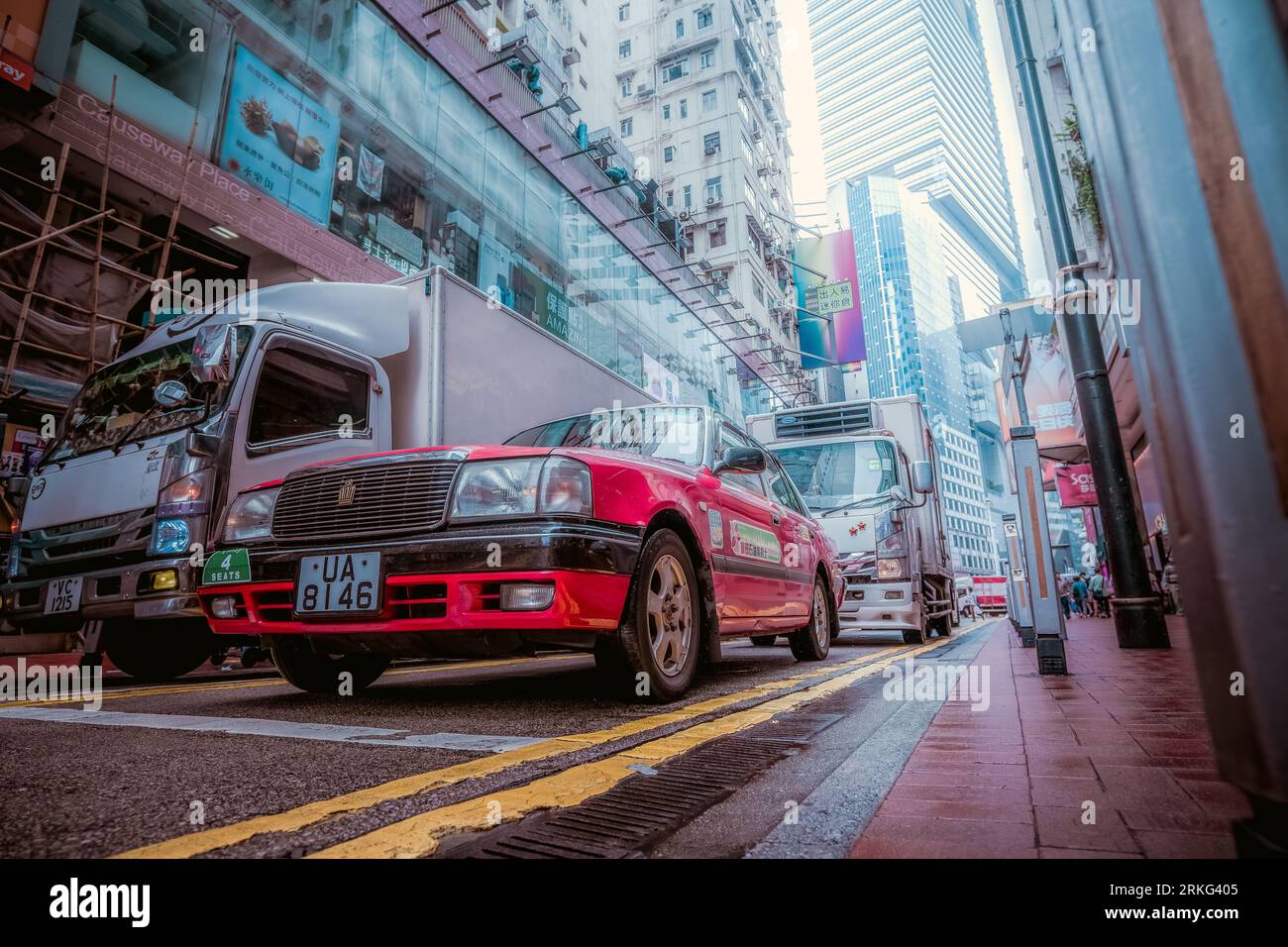 A red taxi at a traffic light in Hong Kong. Low angle view Stock Photo