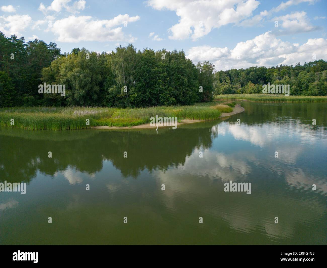 A tranquil scene of a river meandering through a lush green landscape ...