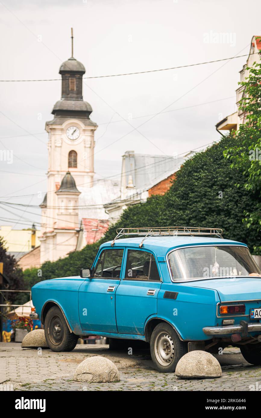 An old blue car on a background of a old European street. Stock Photo