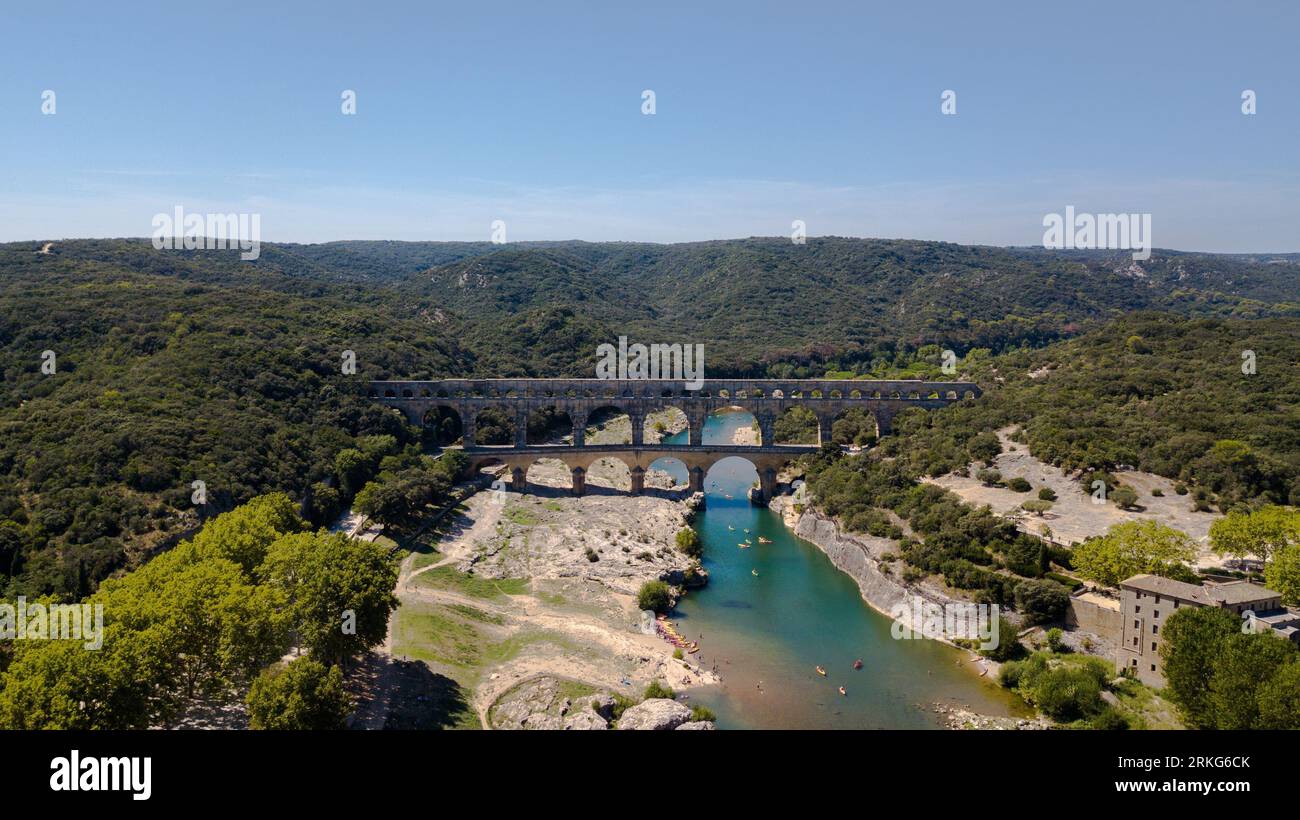 An aerial view of a large bridge stretching across a vast valley below, providing a stunning view of the landscape Stock Photo