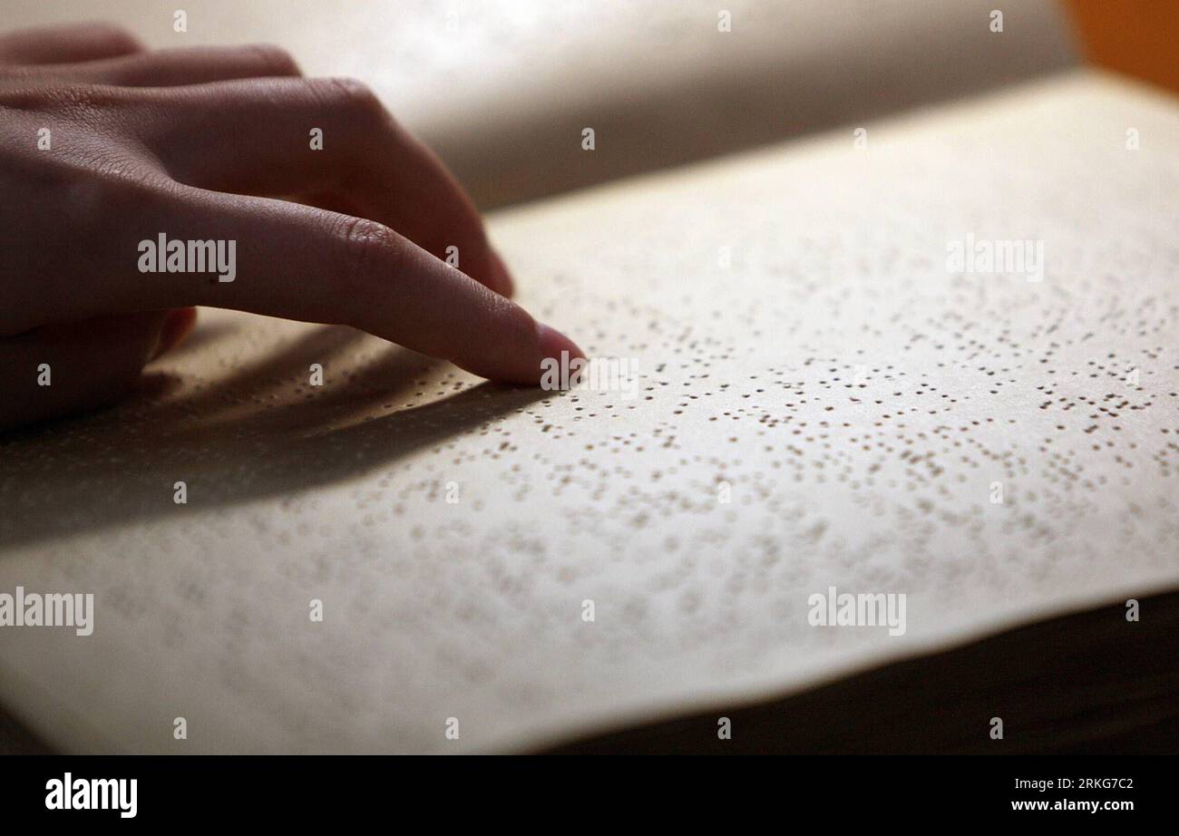 Bildnummer: 55560208  Datum: 30.06.2011  Copyright: imago/Xinhua (110630) -- BEIJING, June 30, 2011 (Xinhua) -- A visually impaired person reads a Braille book at the Chinese National Library for the Blind in Beijing, China, June 30, 2011. The Beijing-based Chinese National Library for the Blind opened a new location on Tuesday. The new location has 28,000 square meters and is divided into many sections that include training and exhibition areas. The new library boasts a collection of over 50,000 Braille books, large-lettered books and audio-books. Facilities in the library are designed in a u Stock Photo