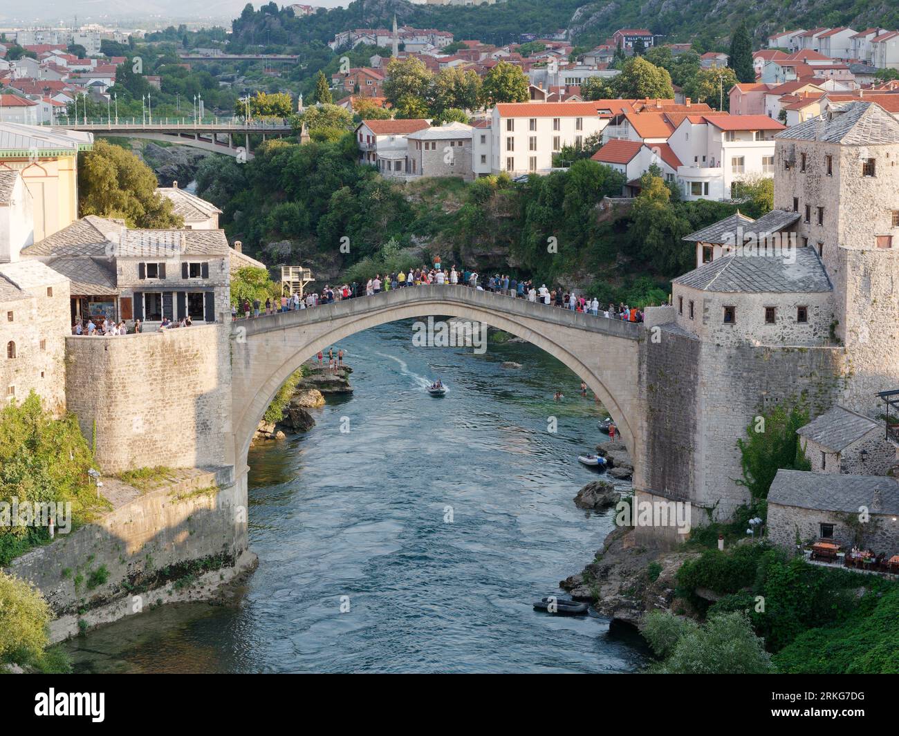 People sightseeing from Stari Most (Old Bridge) over the Neretva River in Mostar, Bosnia and Herzegovina, August 22, 2023. Stock Photo