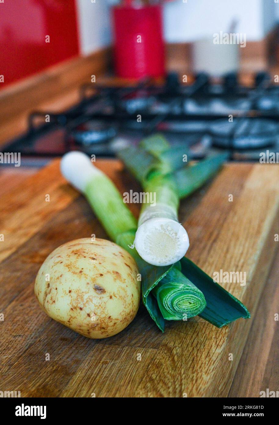 One large potato and two leeks ready for making leek and potato soup Stock Photo
