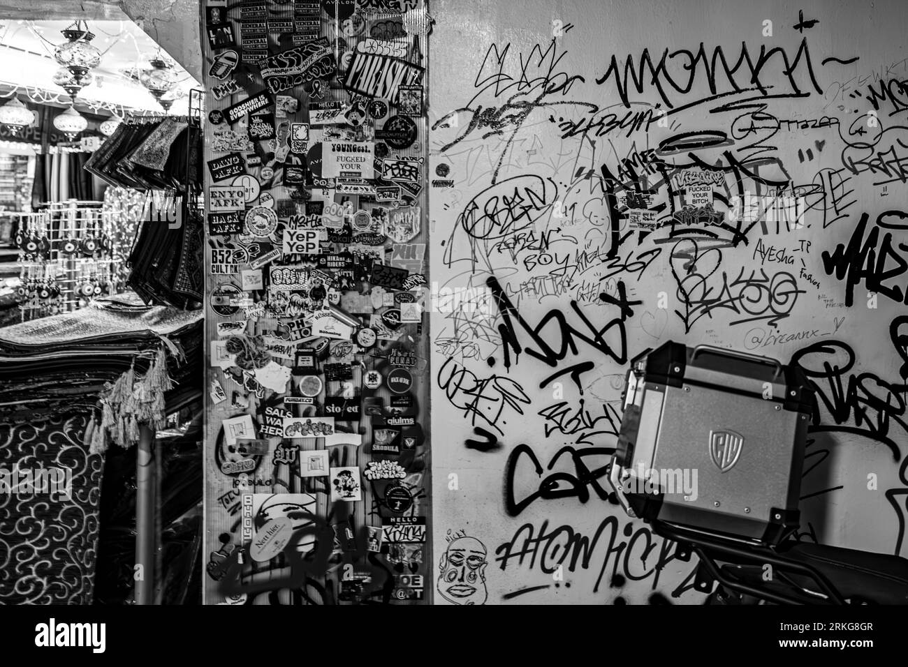 Grafiity and alot of stickers on the wall in black and white Stock Photo