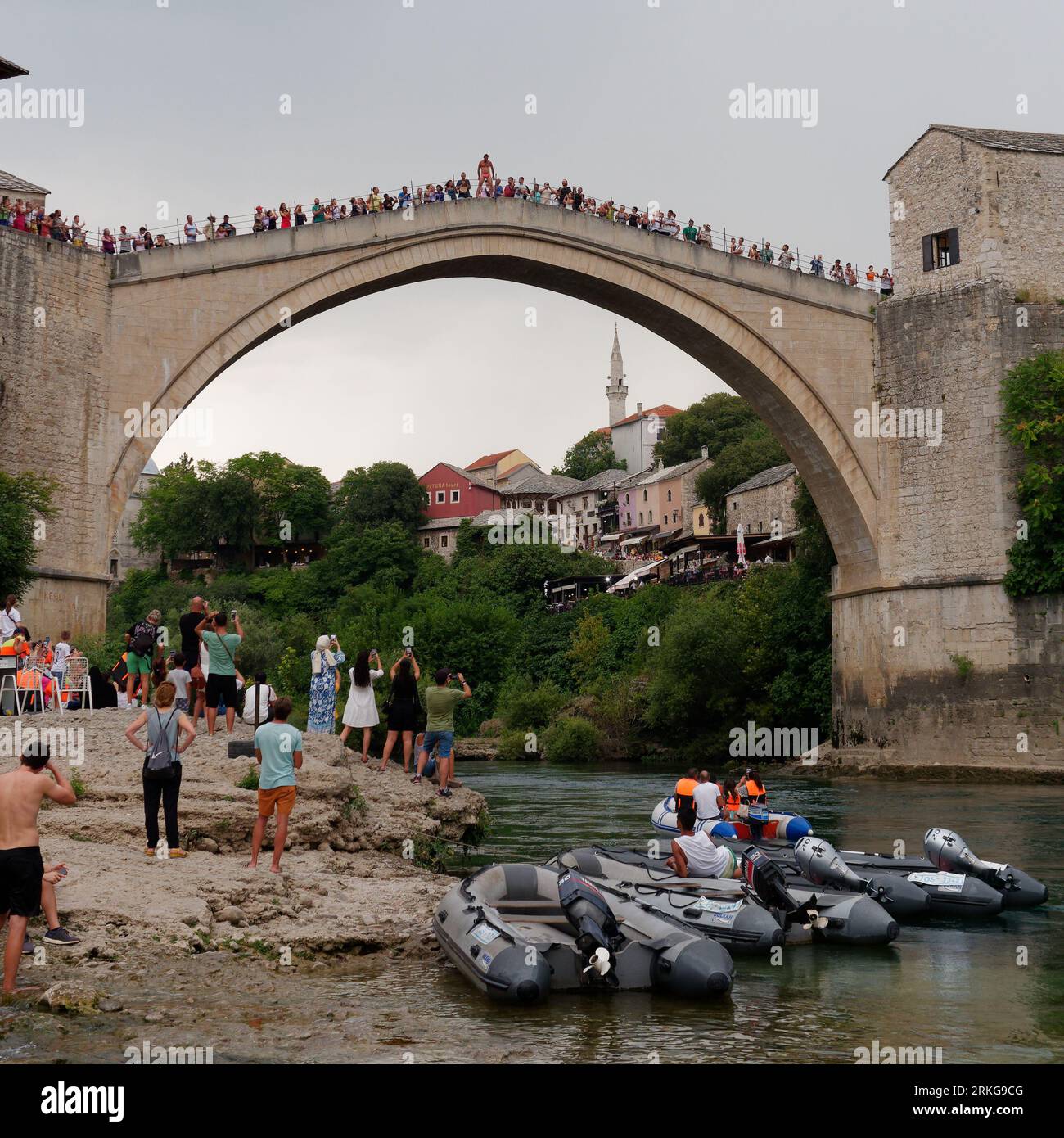 People gather to watch a Bridge Jumper as he prepares to jump from Stari Most (Old Bridge) Mostar, Bosnia and Herzegovina, August 23, 2023. Stock Photo