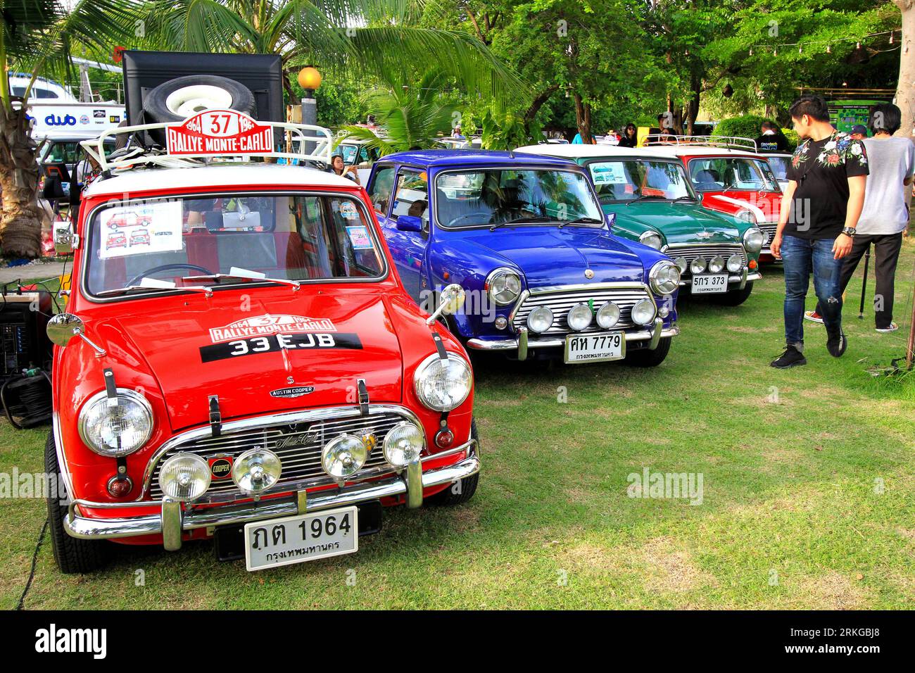 A classic Austin Mini Cooper car is parked on a grassy field in preparation for a Mini on the Beach party Stock Photo