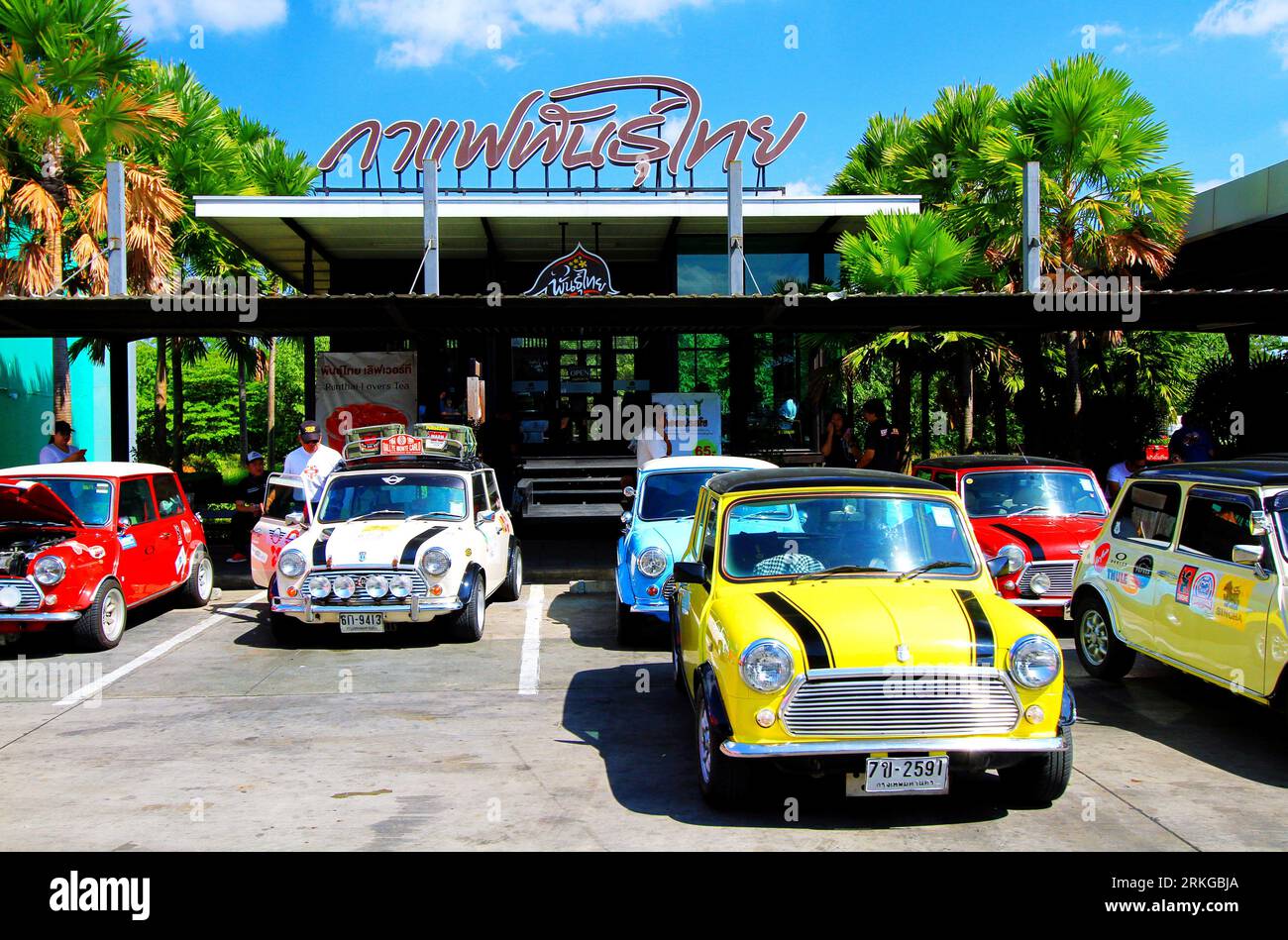 An array of vintage Mini Austin Coopers in a variety of colors are parked along the side of a street Stock Photo