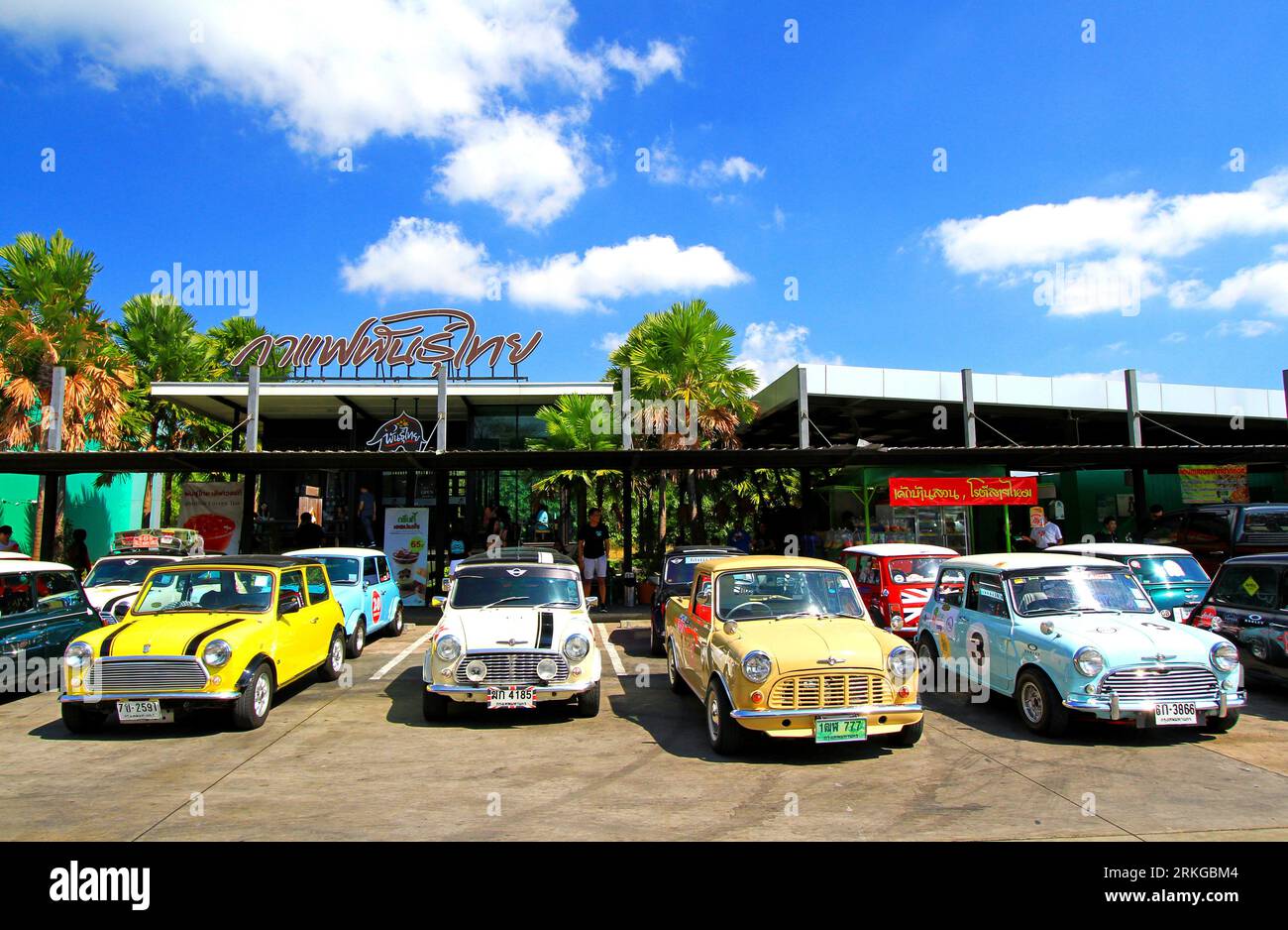 An array of vintage Mini Austin Coopers in a variety of colors are parked along the side of a street Stock Photo