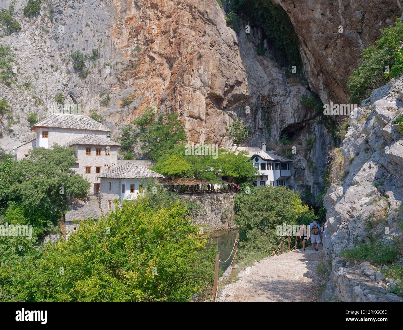 The Blagaj Monastery (or Blagaj Tekija) on the Buna River with tourists on a path in foreground near Mostar, Bosnia and Herzegovina, August 24, 2023. Stock Photo