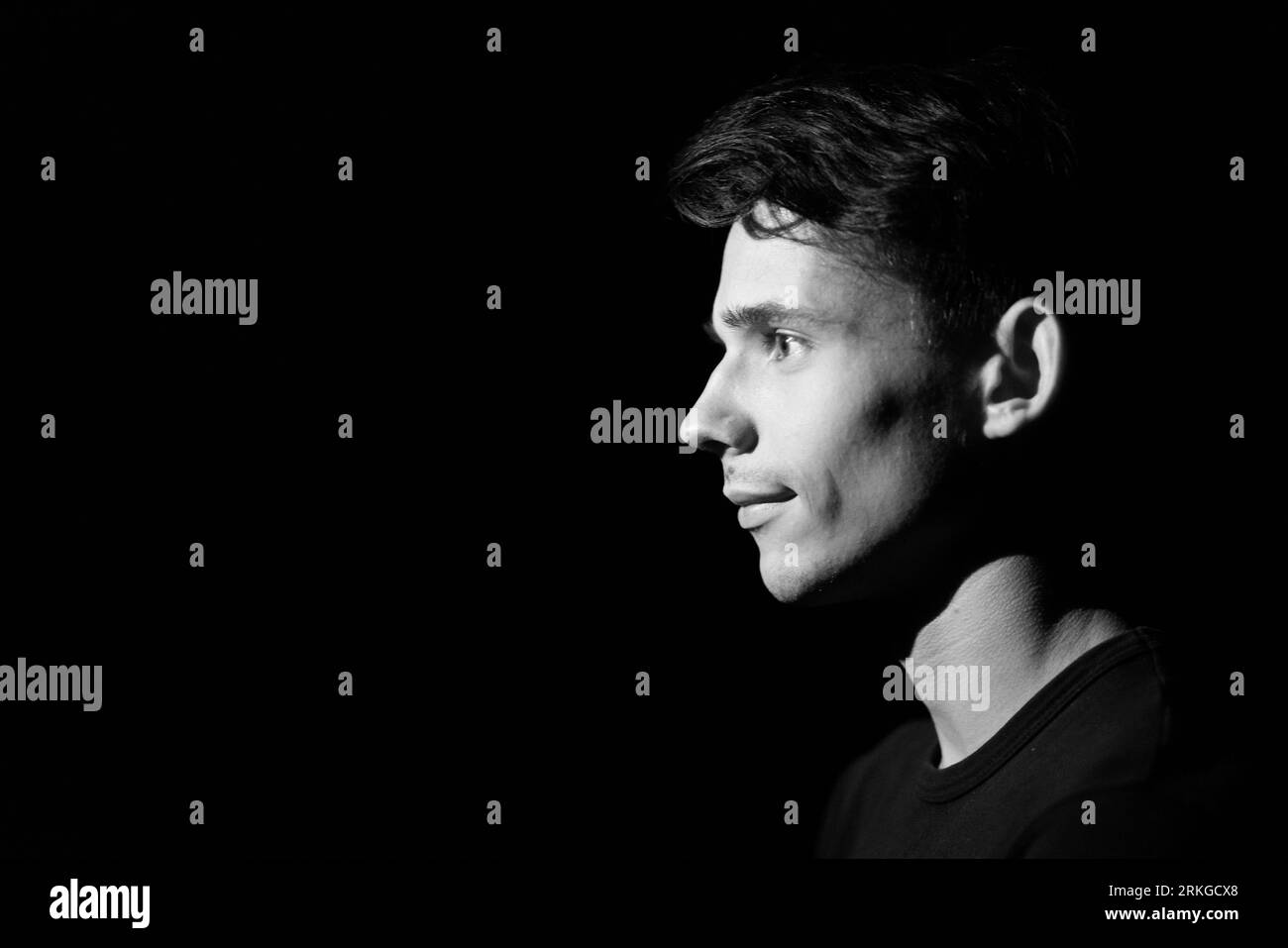 black and white portrait of a young guy on a black background Stock ...