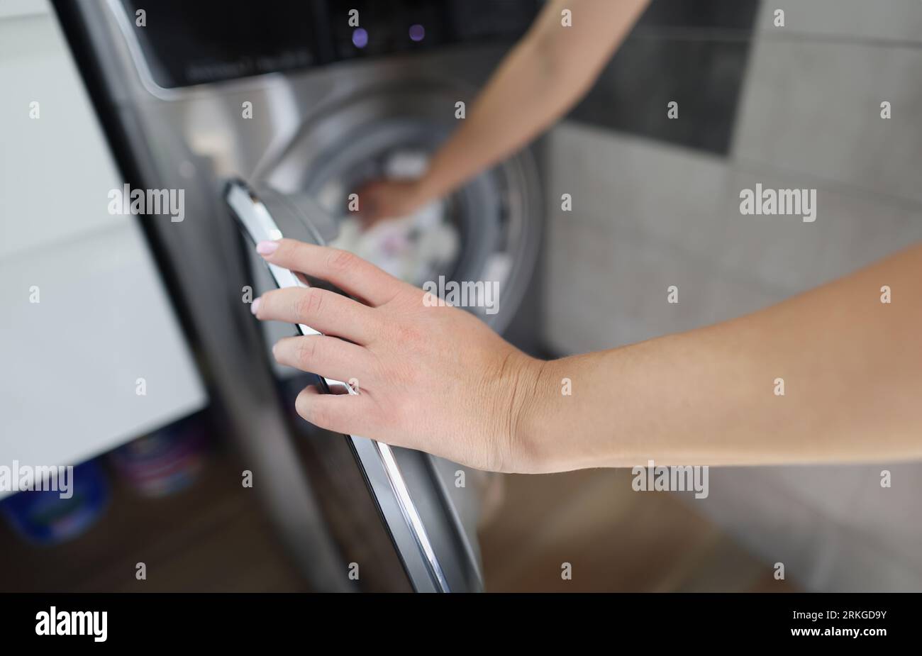 Woman using washing machine hi-res stock photography and images - Alamy