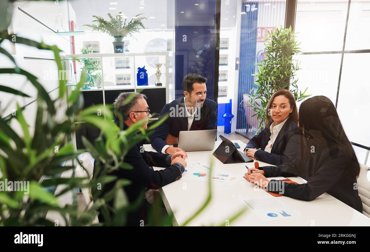 Business entrepreneurs working inside real estate agency - Agents talking about house and buildings market datas - Main focus on men faces Stock Photo