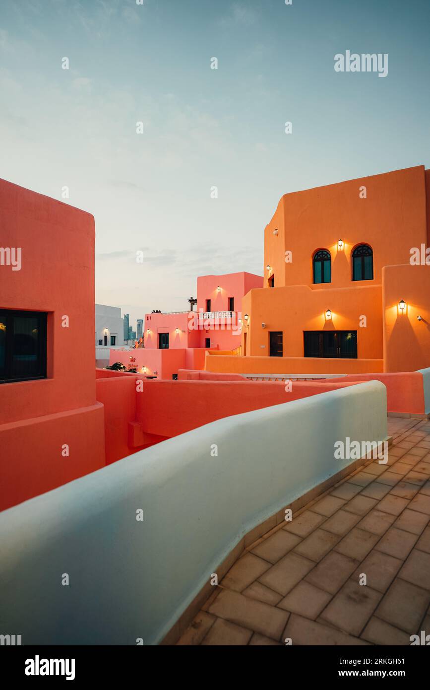 A vertical of colorful houses in twilight in Doha, Qatar Stock Photo ...