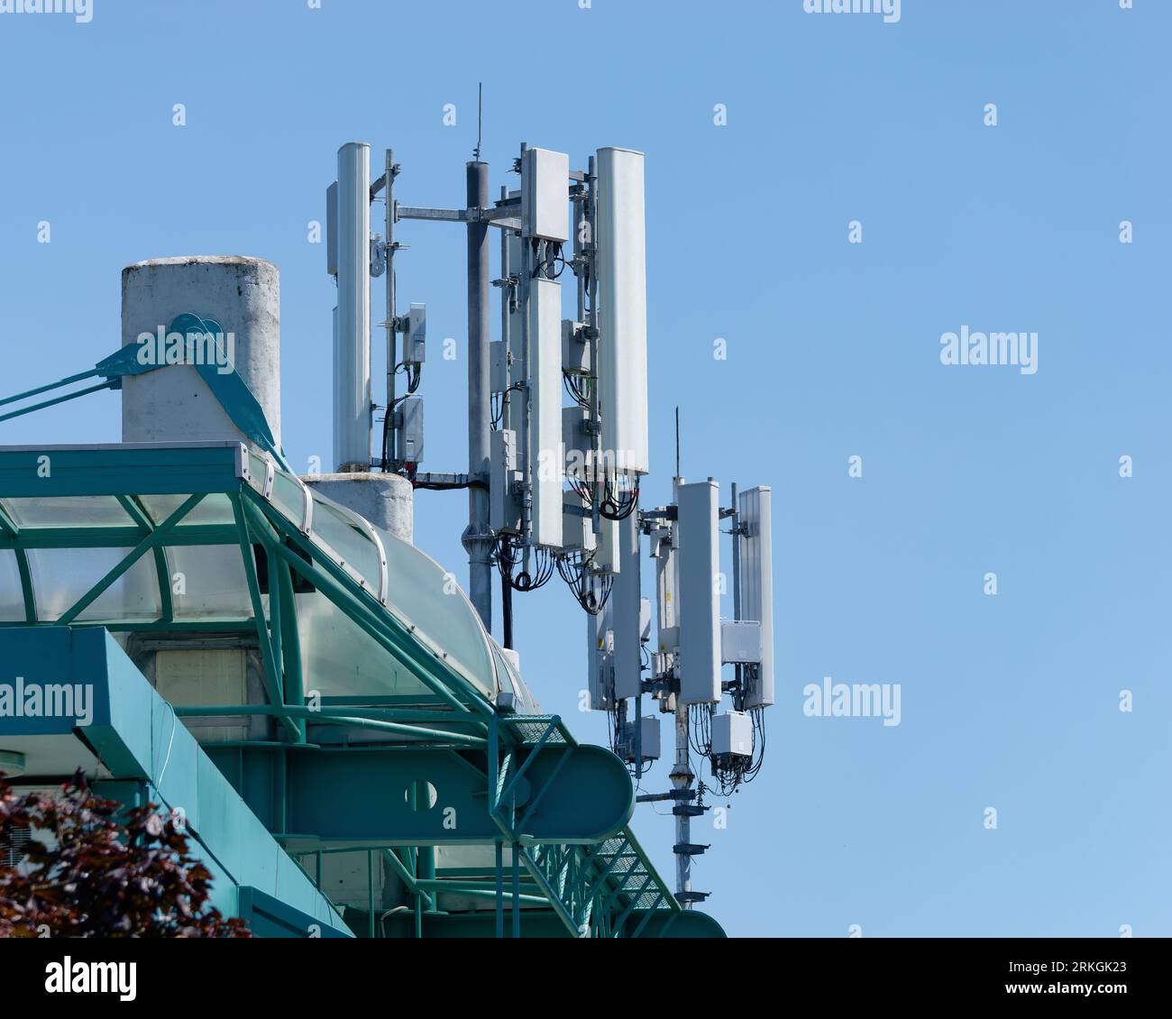 A radio tower with multiple antennas on top of a building Stock Photo