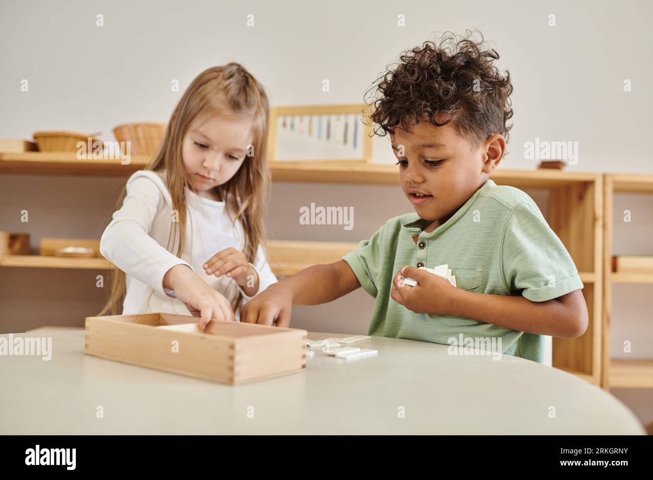 math learning, african american boy playing with girl, montessori school concept, diverse kids